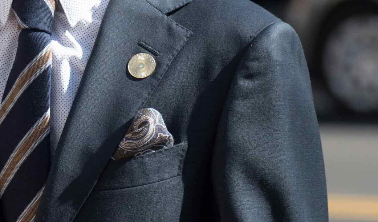 Gold Lapel Pin on Suit Jacket