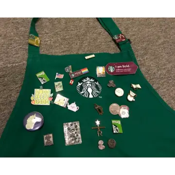 Green apron decorated with custom lapel pins
